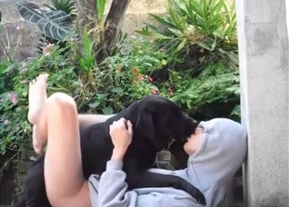 Hoodie hottie makes out with a dog